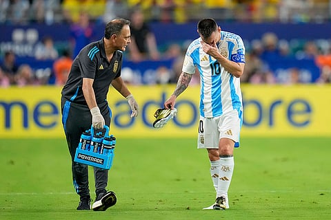 Argentina's Lionel Messi walks off the field injured during final